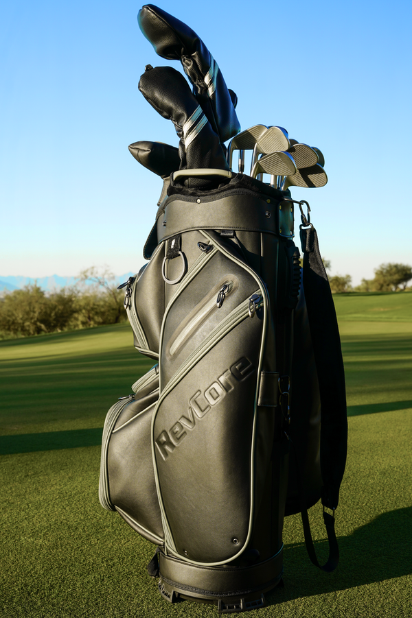 black golf cart bag and clubs on golf course