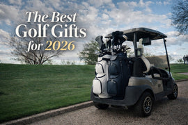 Golf cart on a scenic course path with bright white and navy premium golf bags mounted on the back, under a blue sky with clouds, featuring overlaid text that reads “The Best Golf Gifts for 2026.”